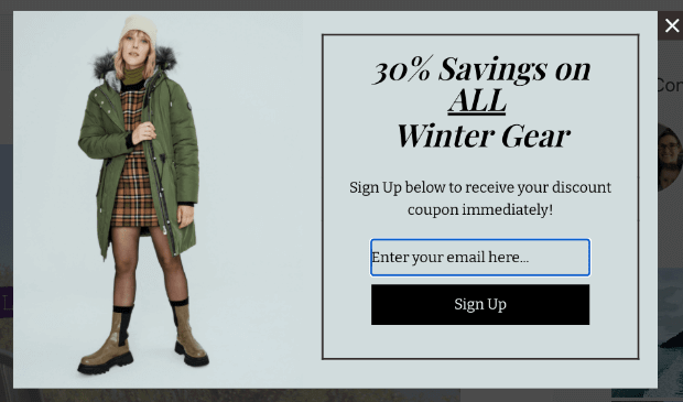 Geotargeting-example-with-winter-clothes-min - OptinMonster Popup that says "30% Savings on ALL Winter Gear" with a photo of a woman in a heavy coat, hat, and boots.